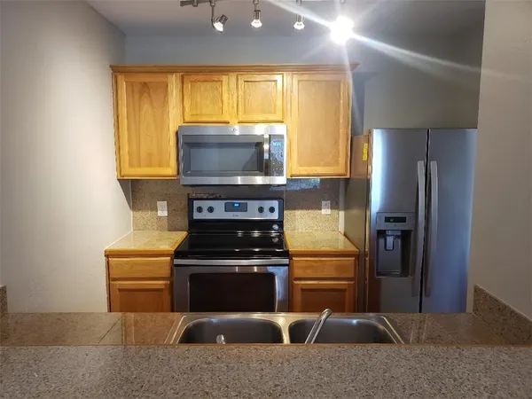 a kitchen with a stove and a microwave