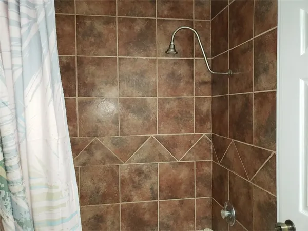 a bathroom with a shower and a sink