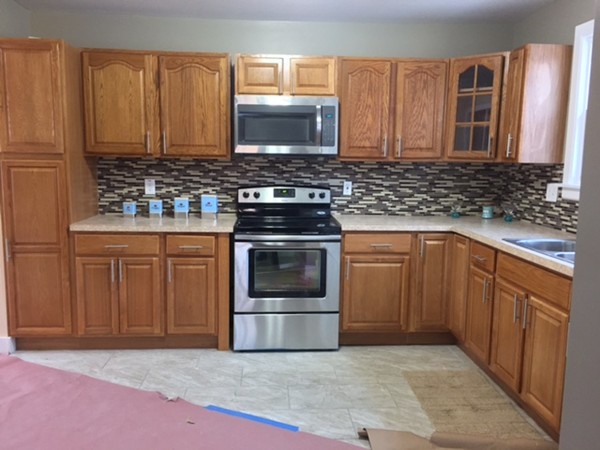 117 Dorset Street Springfield, MA 01108 - Photo 1 of 1 a kitchen with granite countertop a stove top oven microwave and cabinets