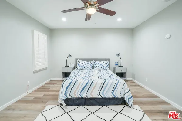 a bedroom with a bed and window