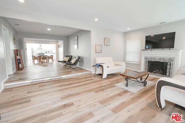 a living room with furniture fireplace and flat screen tv
