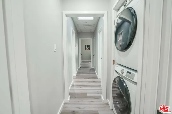 a view of a hallway with washer and dryer