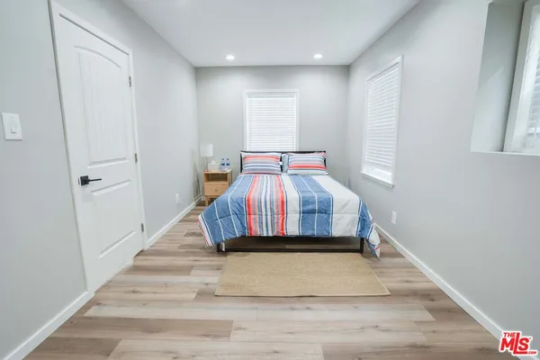 a room with a bed and a rug