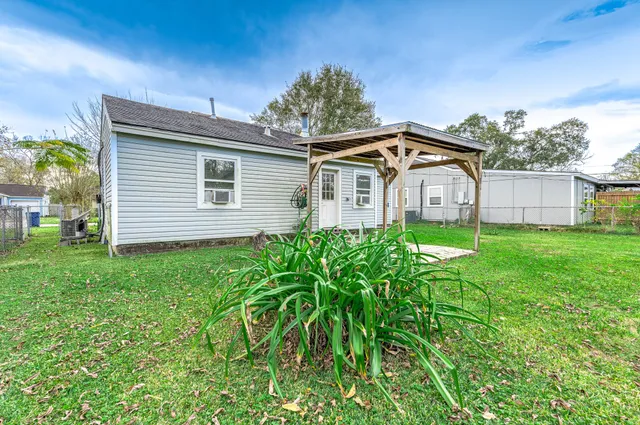a front view of a house with a garden and plants