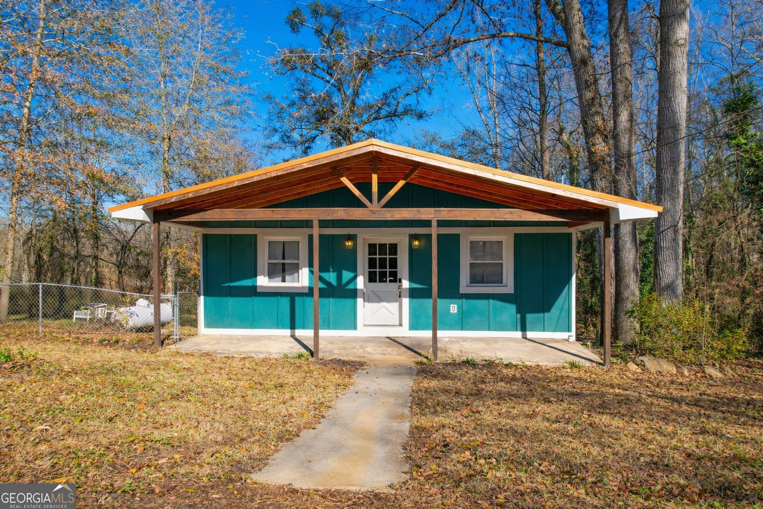 a front view of a house with a garden and patio
