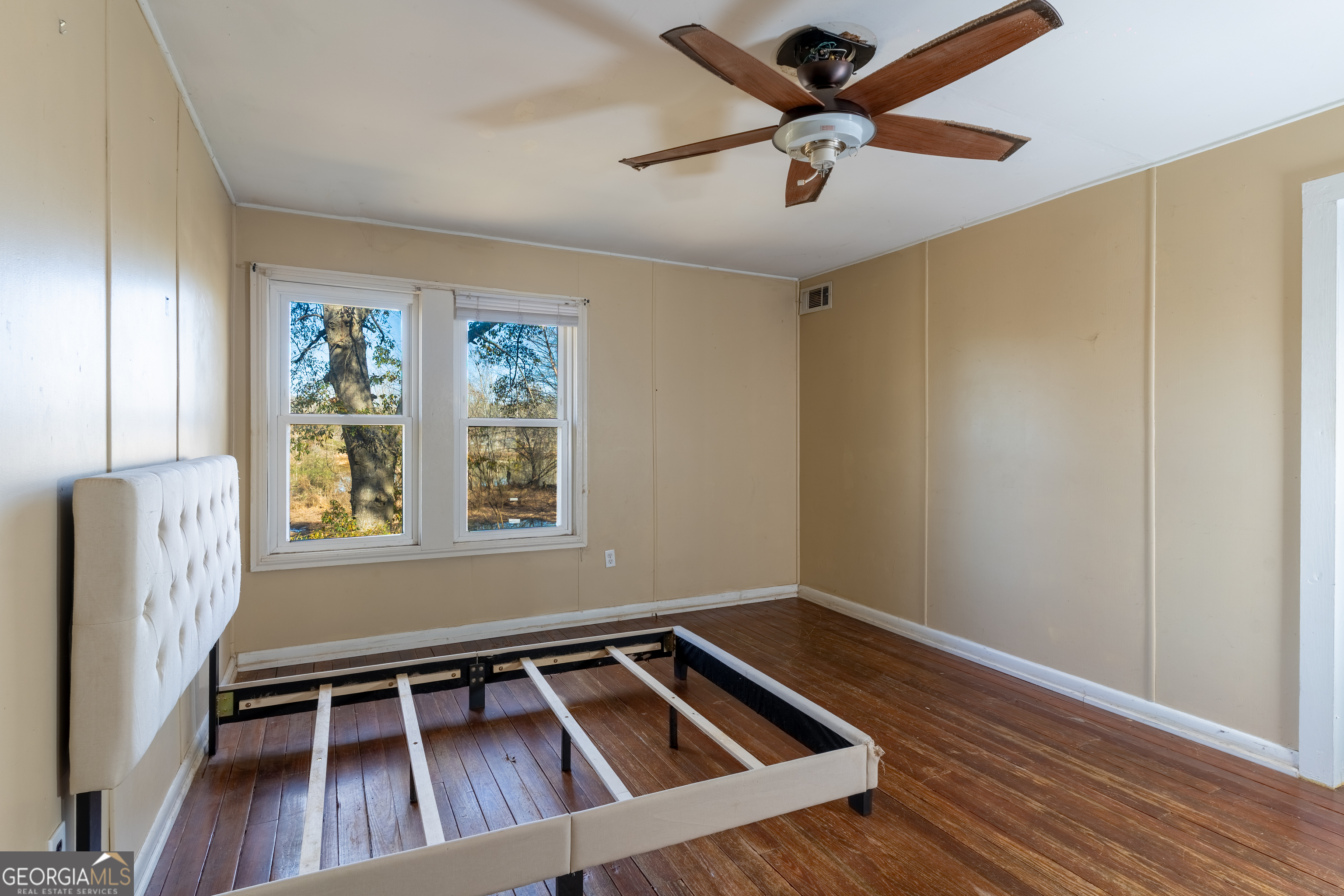 139 Cherokee Drive Jackson, GA 30233 - Photo 14 of 34 a view of an empty room with a window and wooden floor