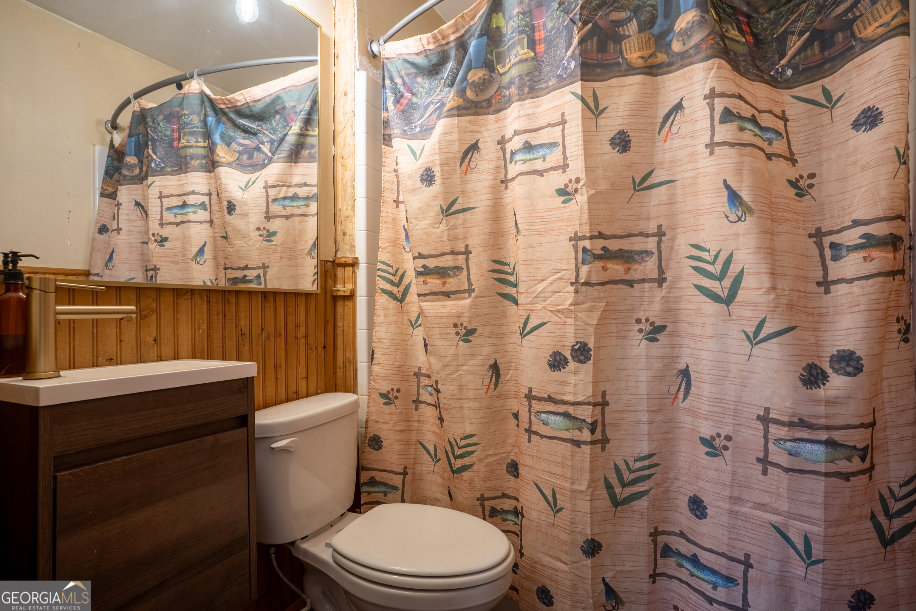 139 Cherokee Drive Jackson, GA 30233 - Photo 15 of 34 a white toilet sitting next to a bathroom sink
