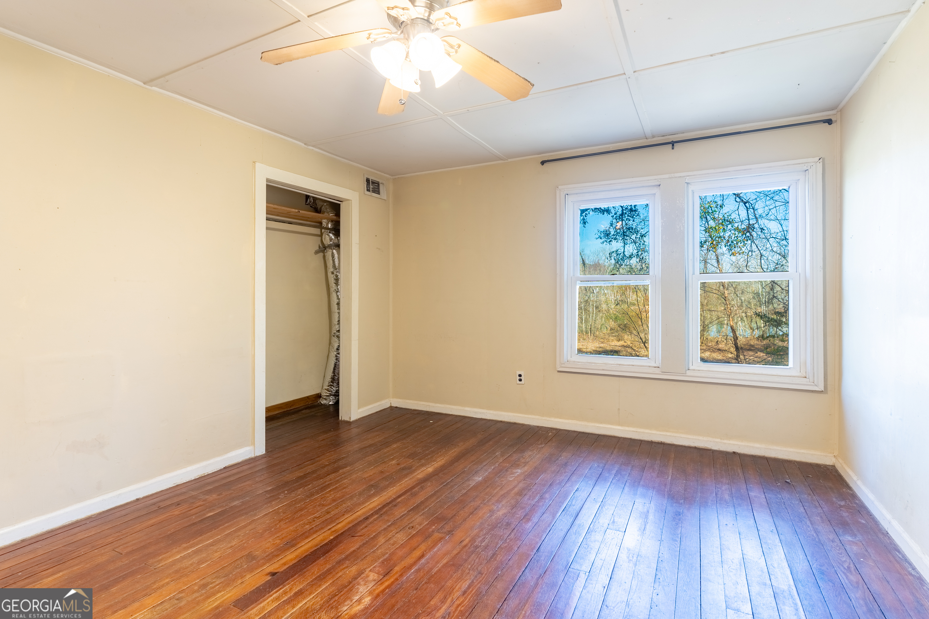 139 Cherokee Drive Jackson, GA 30233 - Photo 16 of 34 an empty room with wooden floor and windows