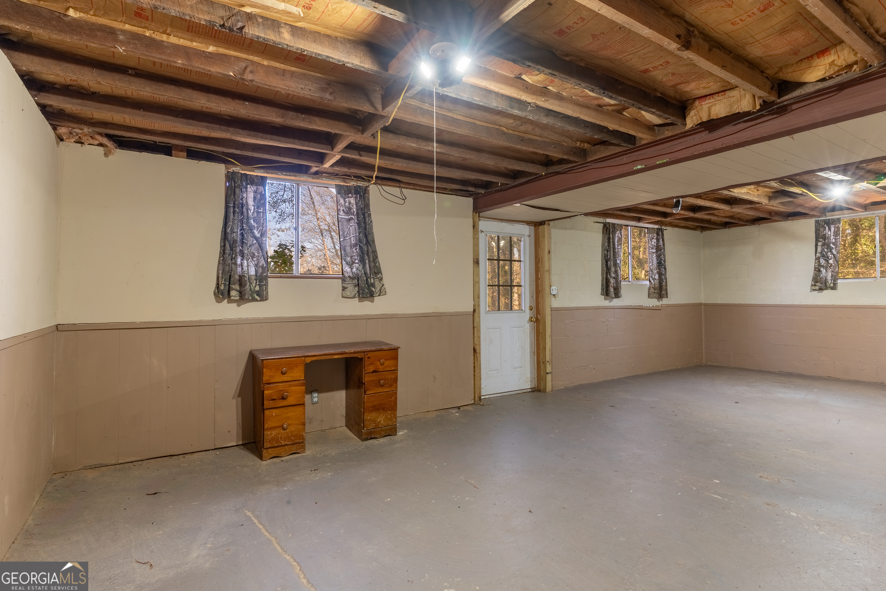 139 Cherokee Drive Jackson, GA 30233 - Photo 20 of 34 a view of an empty room with wooden cabinets and windows