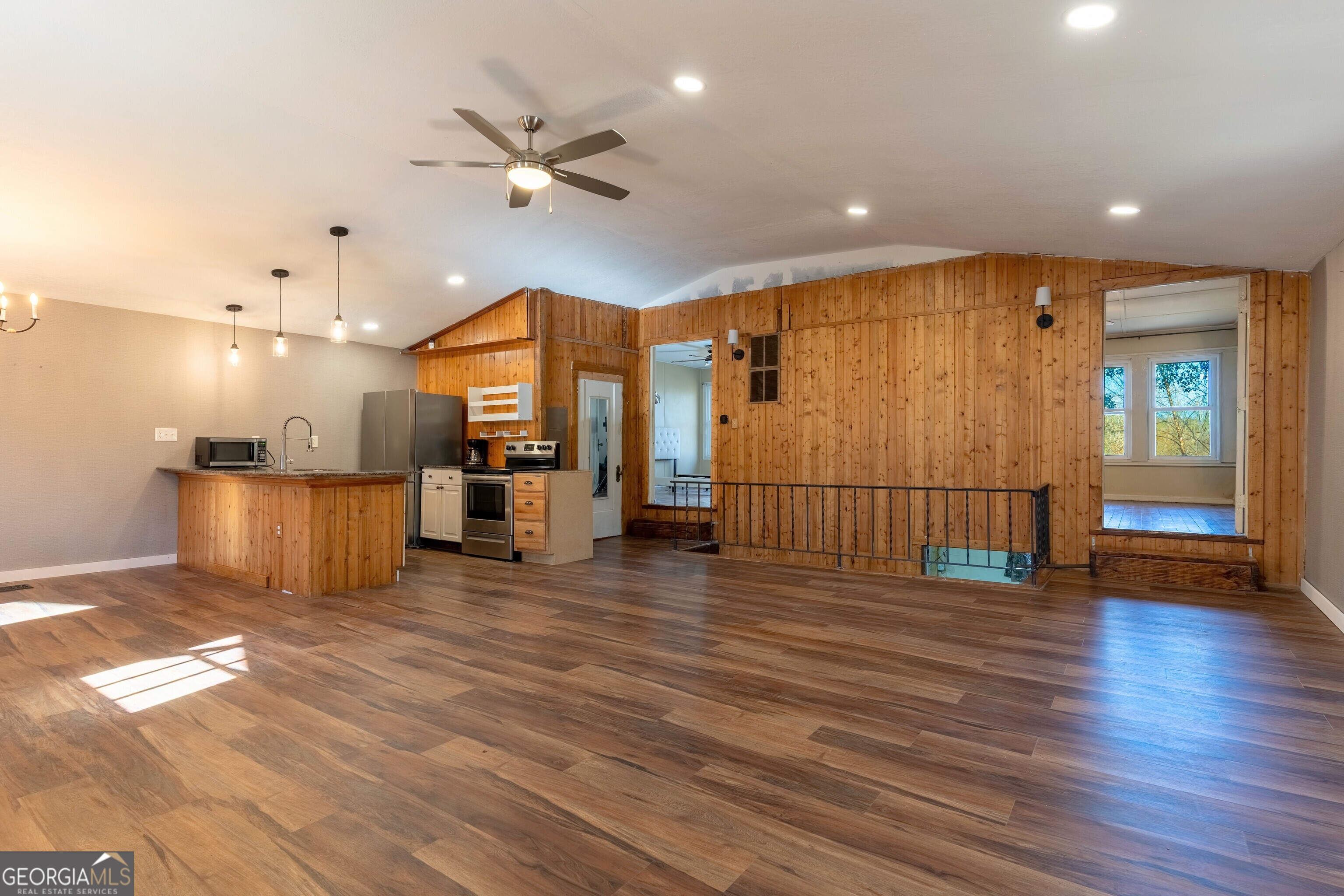 139 Cherokee Drive Jackson, GA 30233 - Photo 6 of 34 a view of a living room with wooden floor and a ceiling fan