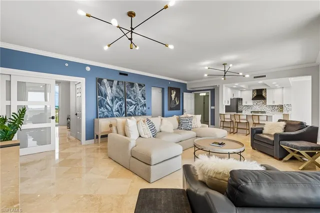 a living room with furniture and kitchen view
