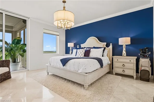 a spacious bedroom with a bed and a chandelier