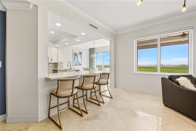 a dining room with furniture and a window
