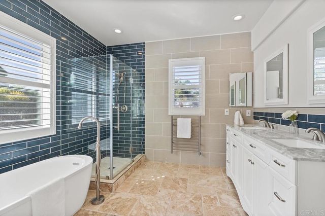 a view of a backyard with potted plants and large trees