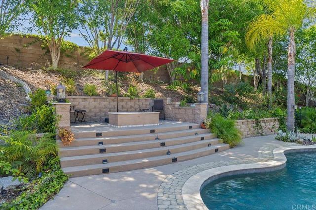 an aerial view of a house with yard patio and outdoor seating