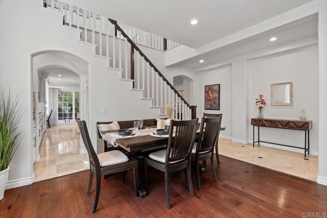 a living room with furniture a fireplace a flat screen tv and a large window