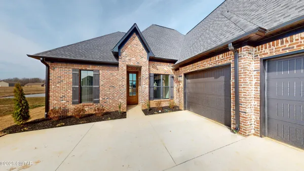 a front view of a house with yard
