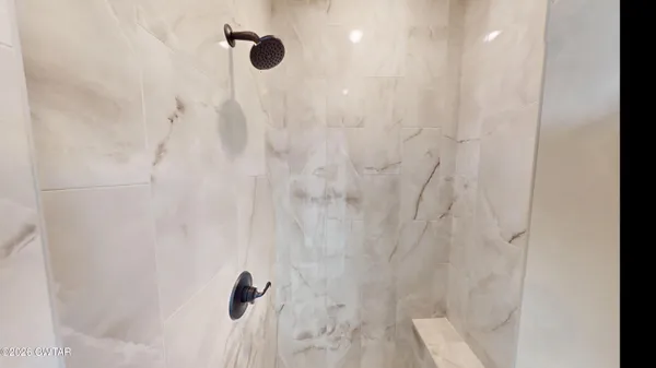 a bathroom with a granite countertop sink toilet and mirror