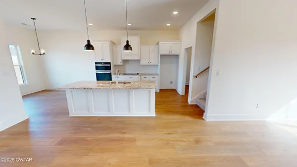 a very nice looking space with wooden floor and a window