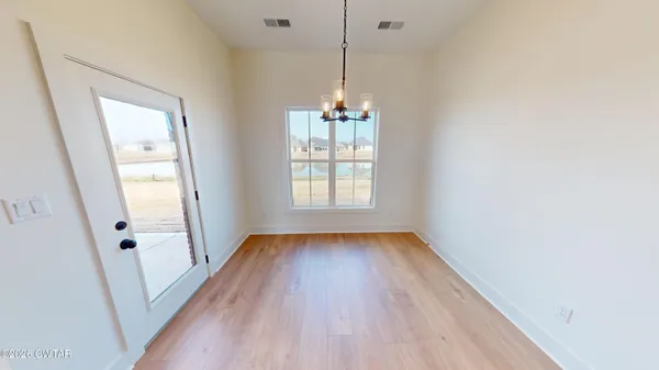 a kitchen with kitchen island a stove a sink a refrigerator and a wooden floor