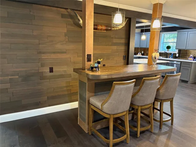 a dining room with a wooden table and chairs