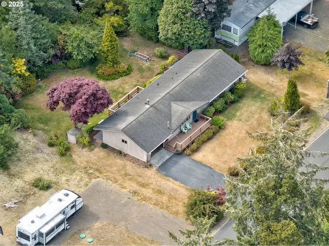 an aerial view of a house with a yard and trees