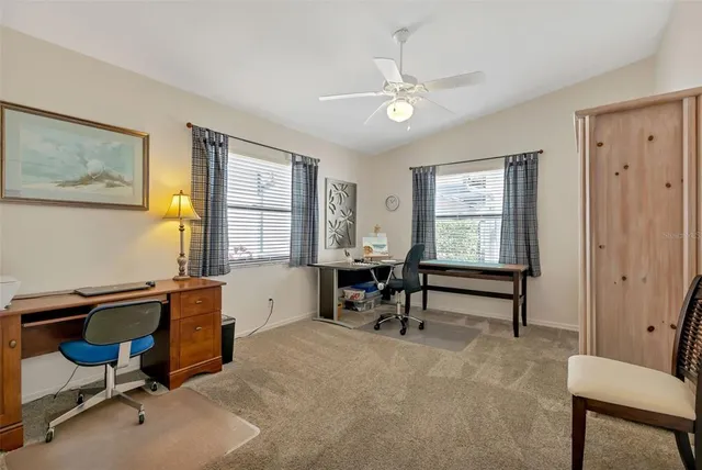 a view of a workspace with furniture and a window