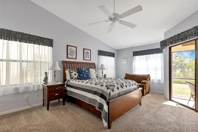 a spacious bedroom with a bed and a large window