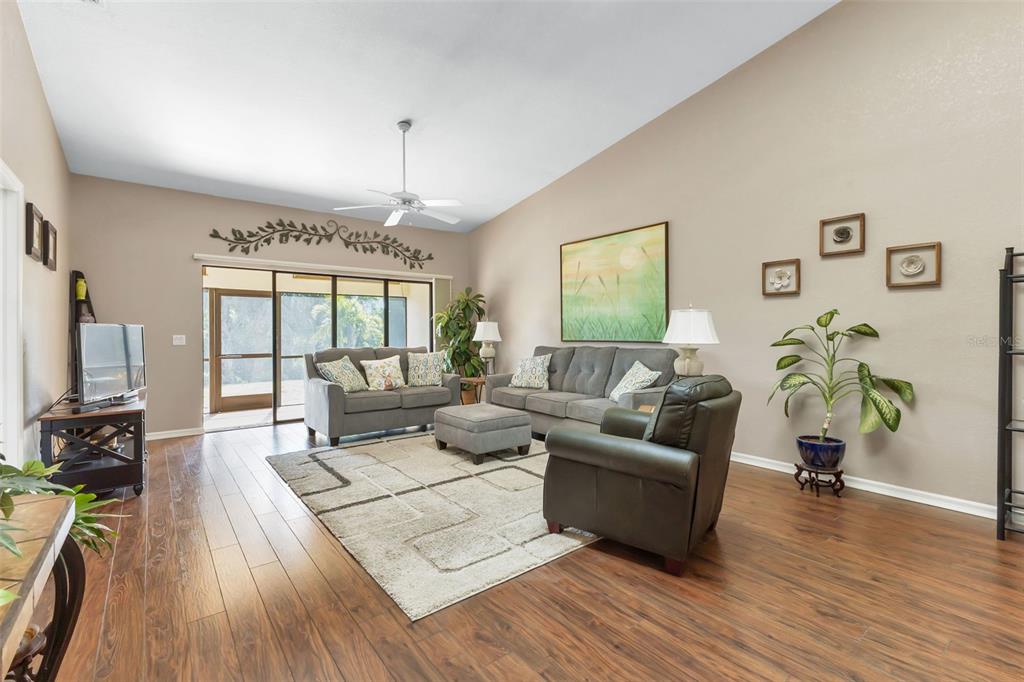 5036 San Rocco Court Punta Gorda, FL 33950 - Photo 10 of 13 a living room with furniture a flat screen tv and a floor to ceiling window