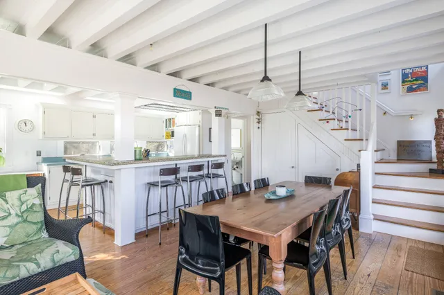 a dining room with furniture and wooden floor