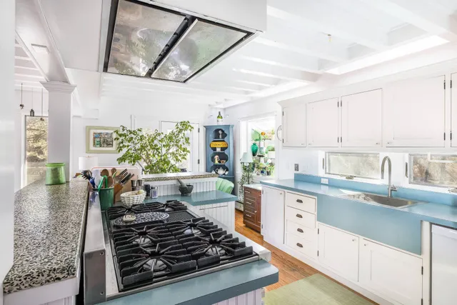a kitchen with stove and cabinets