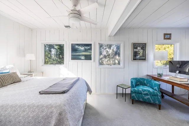 a bedroom with a bed and a couch