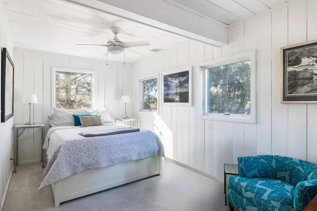 a bedroom with a bed a couch and a window