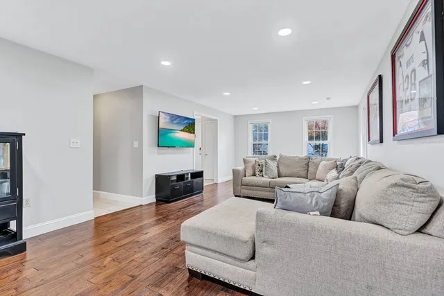 a living room with furniture flat screen tv and a fireplace