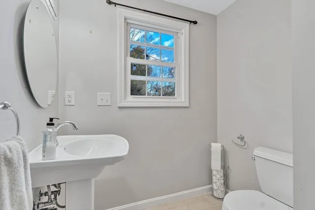 a bathroom with a sink mirror and toilet