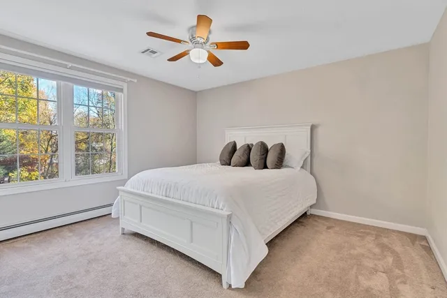 a bedroom with a bed and a large window
