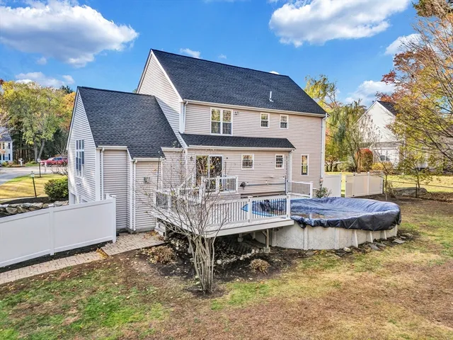 a view of house with backyard and outdoor seating
