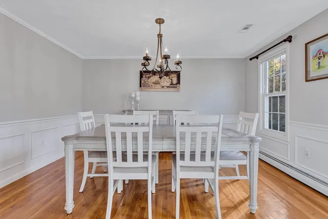 a view of a dining room with furniture wooden floor and a chandelier