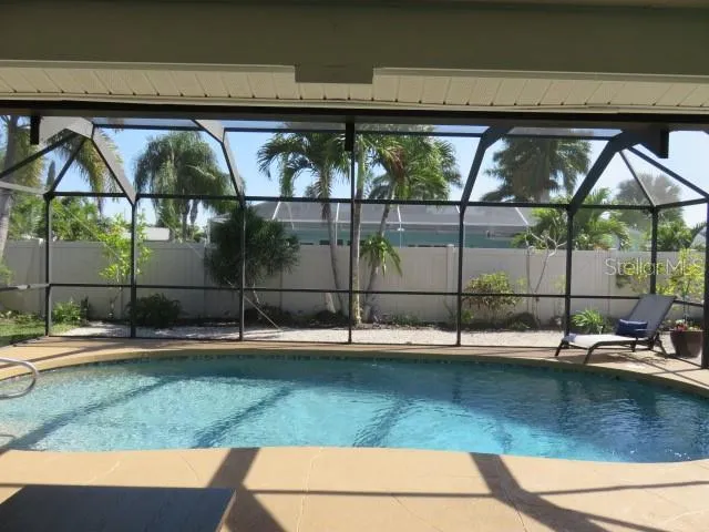 a view of swimming pool with outdoor seating