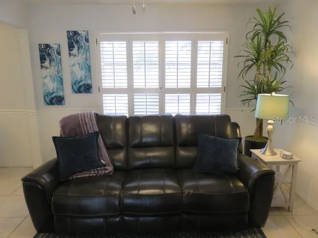 a living room with furniture and a window