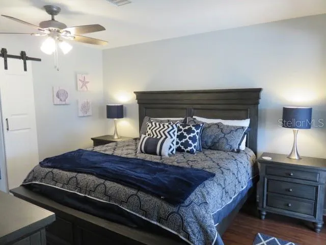 a bedroom with a bed and ceiling fan
