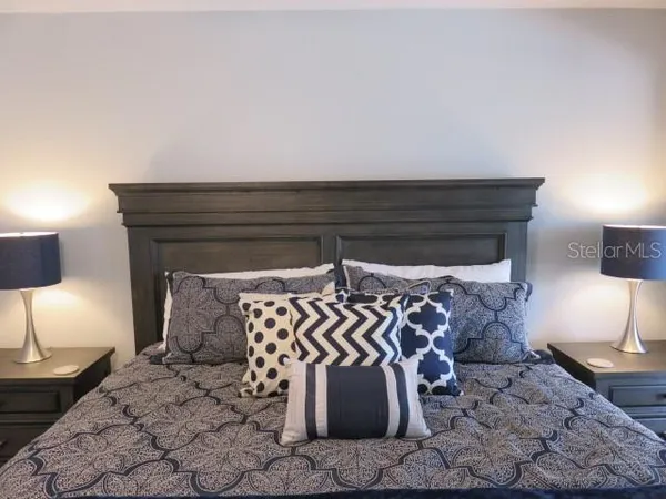 a bed with a night stand and a lamp