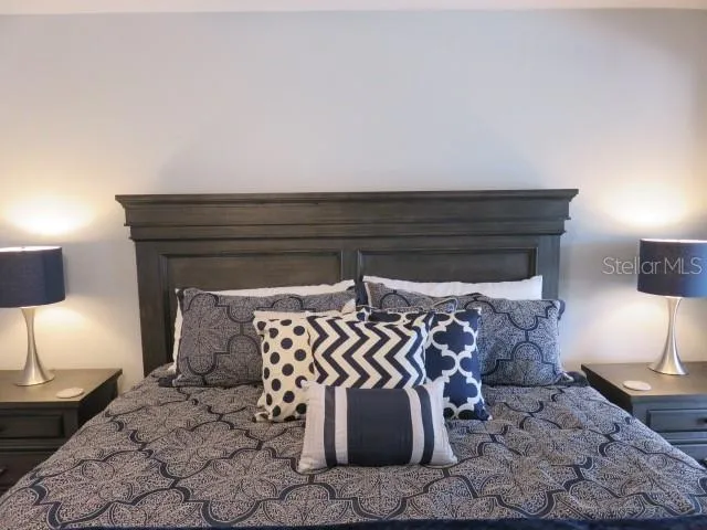 a bed with a night stand and a lamp