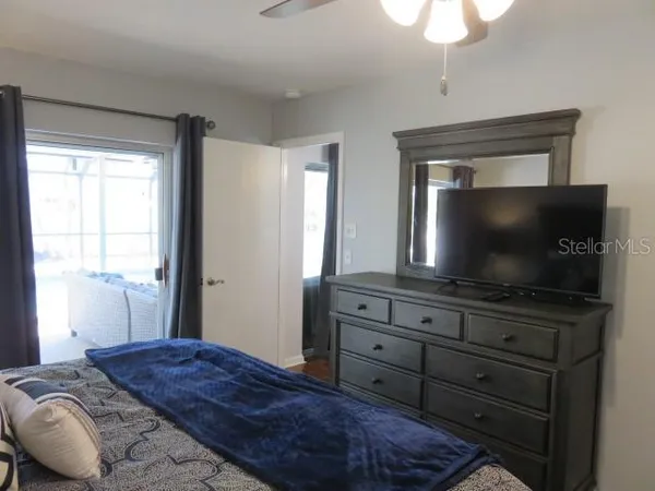 a bedroom with a bed and a flat screen tv