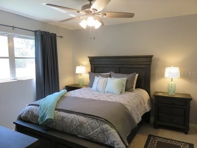 a bedroom with a bed and a window