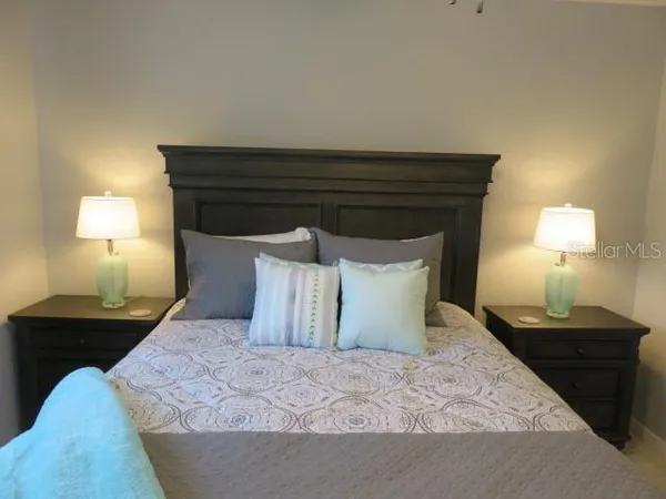 a bedroom with a bed and a night stand