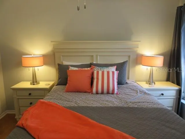 a bedroom with a bed and a lamp