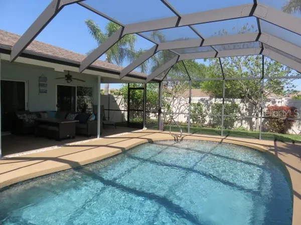 a backyard of a house with a fountain and a outdoor seating
