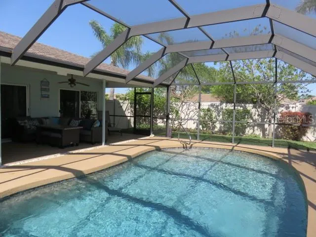 a backyard of a house with a fountain and a outdoor seating