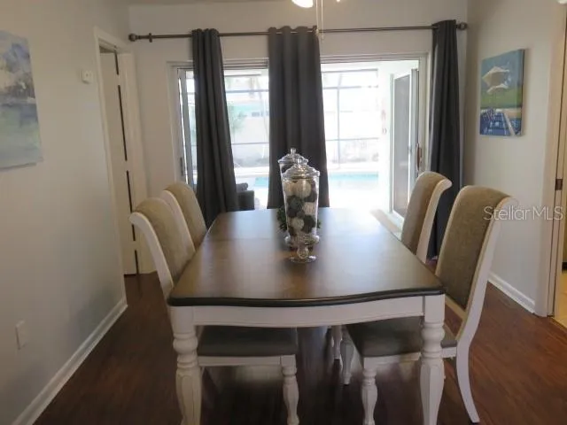 a view of a dining room with furniture and wooden floor